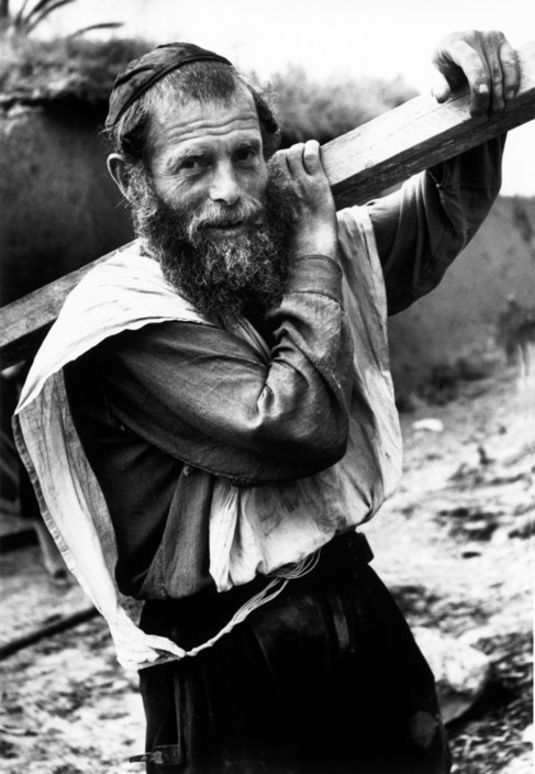 Man Carrying Wooden Beam